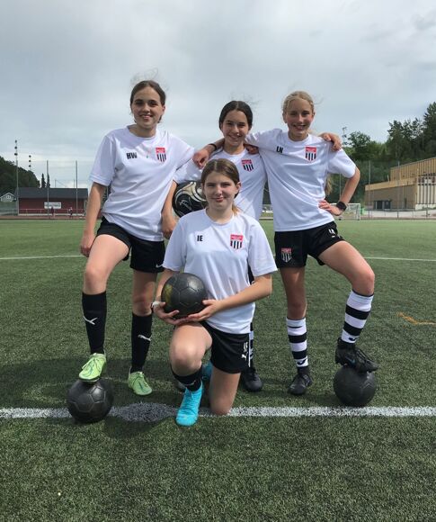 4 Girls posing in football kit